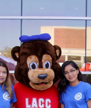 Cubby mascot standing with a group of students