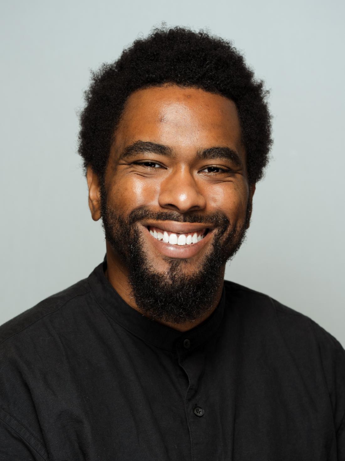 Headshot of Professor Xavier Burgin against a white backdrop