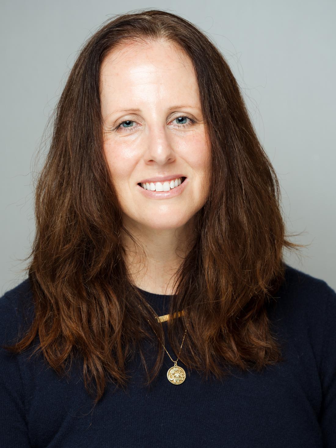 Headshot of Adjunct Cinema Professor, Dr. Mary Samuelson against a white backdrop