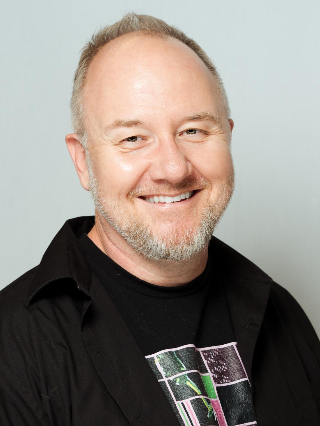 Headshot of professor Joel Trudgeon against a white backdrop